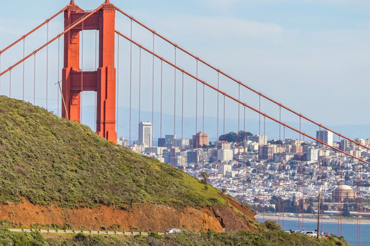 Iconic view of the Golden Gate Bridge and San Francisco skyline from a hillside.